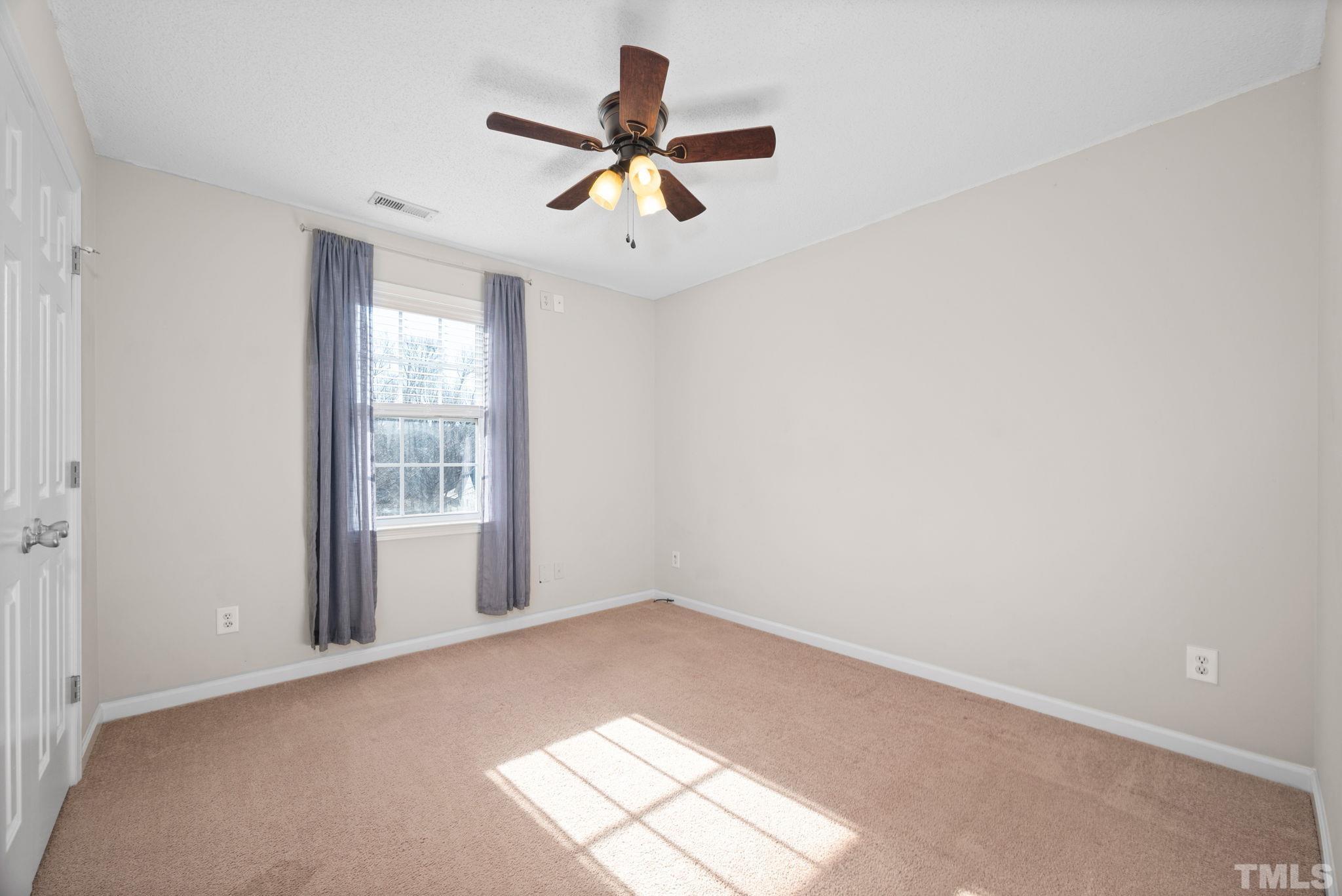 124 Gentle Rio Court Garner, NC 27529 - Photo 31 of 37 an empty room with windows and fan