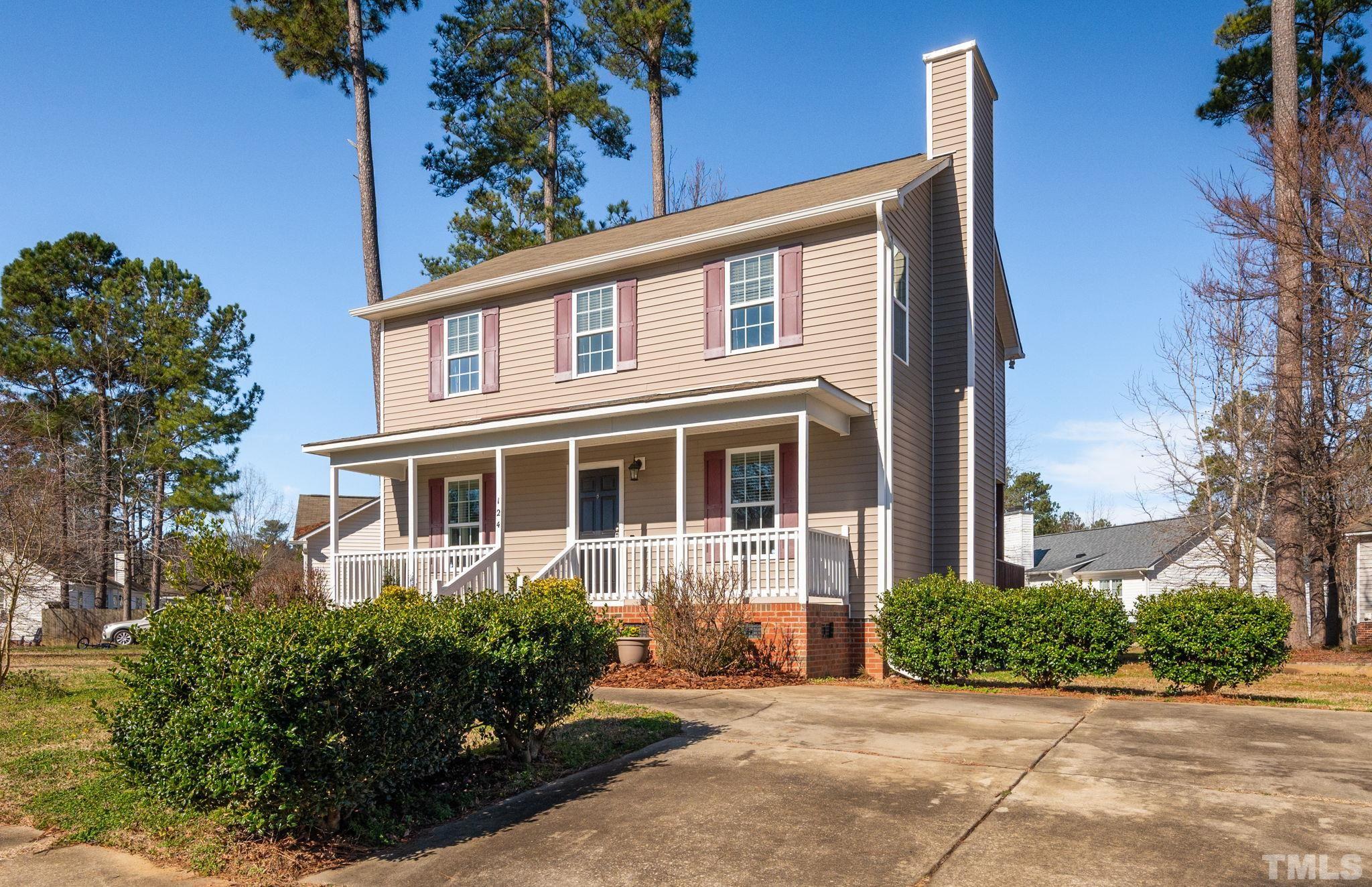 124 Gentle Rio Court Garner, NC 27529 - Photo 6 of 37 a front view of a house with a yard