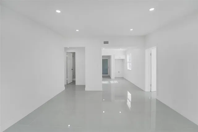a view of a kitchen with white cabinets