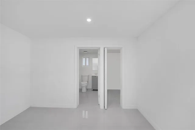 a white toilet sitting next to a bathroom sink