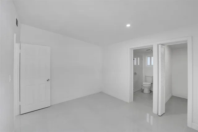 a bathroom with a toilet a sink and shower