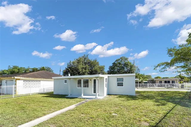 a view of a house with swimming pool and sitting area