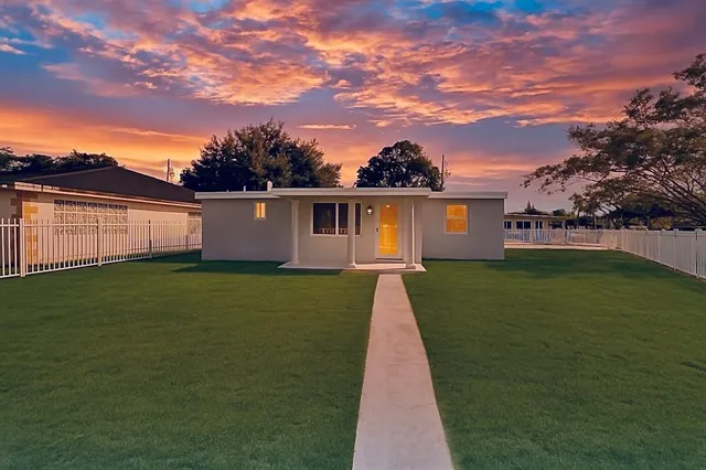 a view of a house with a yard and garage
