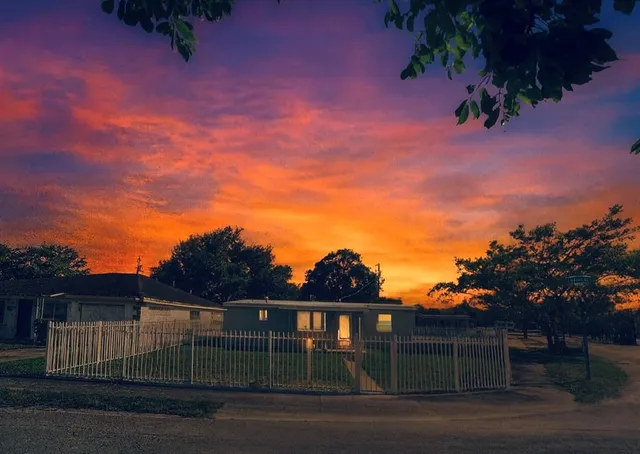 a front view of a house with yard and seating area