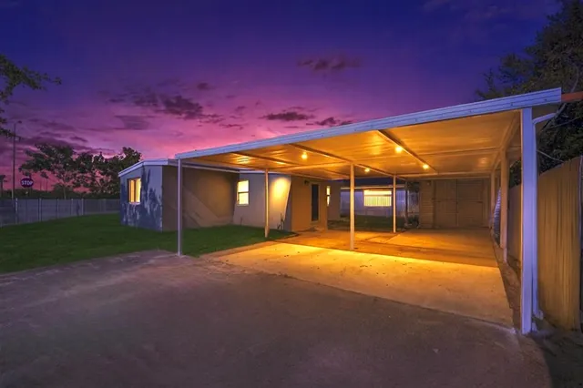 a street view with flower plants and wooden fence