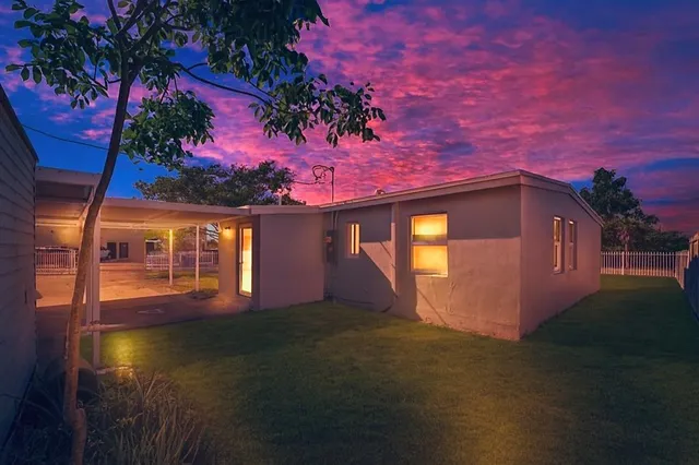 a view of a house with a yard and garden
