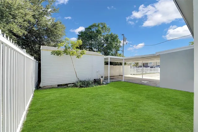 a view of a house with a swimming pool yard and sitting area