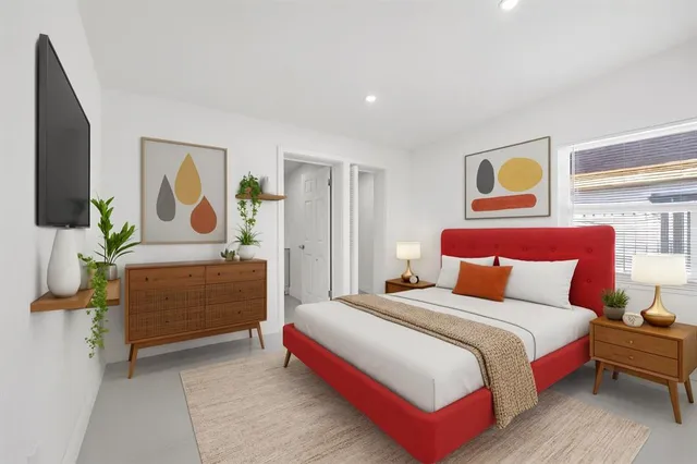 a bedroom with a bed and a dresser