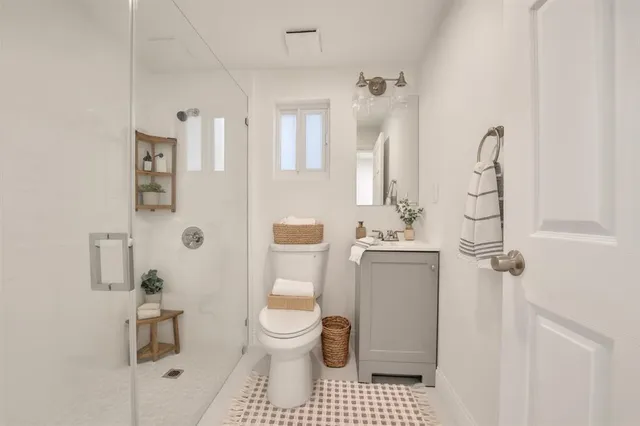 a bathroom with a toilet sink and shower