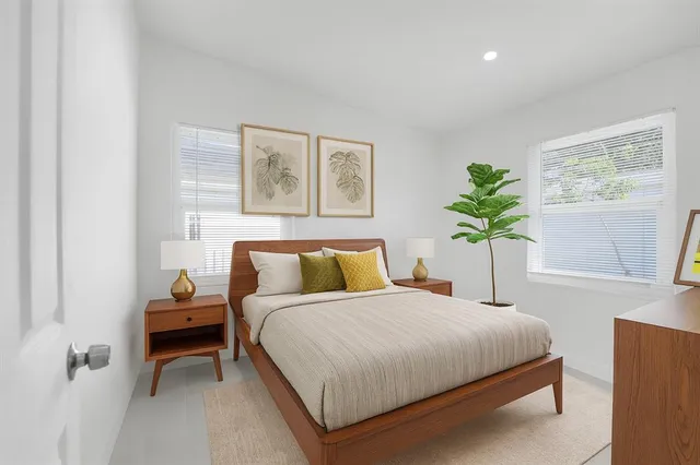 a bedroom with a bed and a painting on the wall