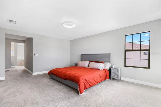 a bedroom with a bed and window