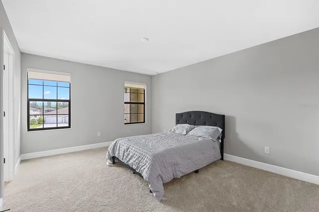 a bedroom with a bed and window