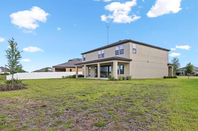 an aerial view of a house with a garden and swimming pool