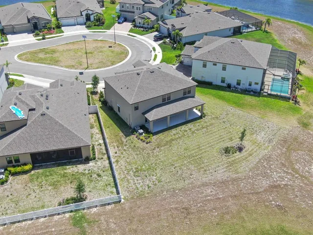 an aerial view of a swimming pool with outdoor seating