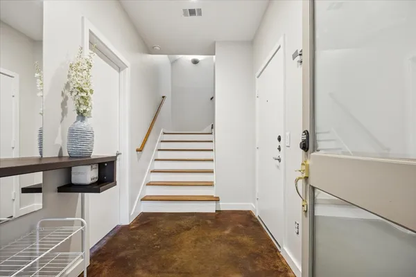 a view of entryway with furniture and wooden floor