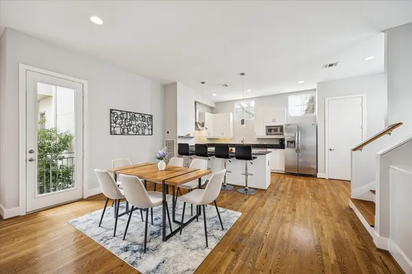 a view of a dining room with furniture and wooden floor