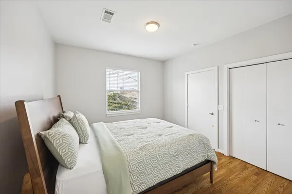 a bedroom with a bed and a window