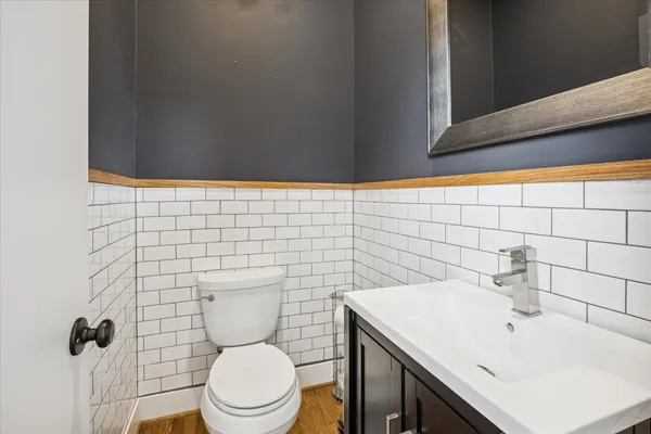 a bathroom with a sink a toilet and a mirror