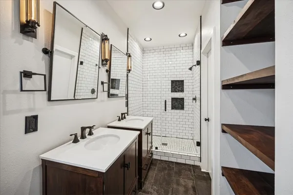 a bathroom with a sink a mirror and a shower