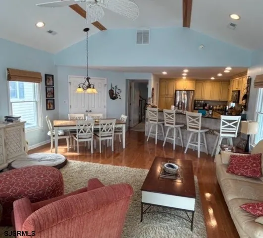 a living room with lots of furniture and a large window