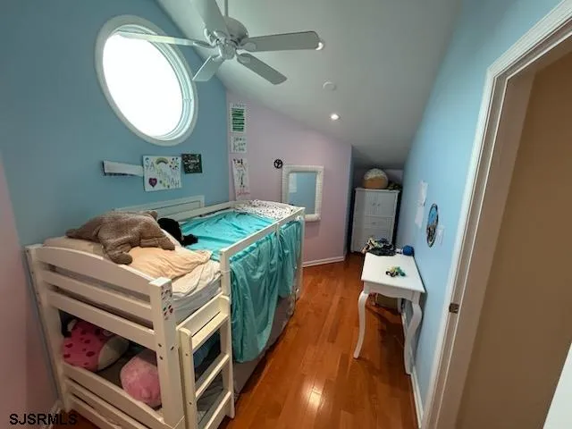 a bedroom with a bed and a mirror in it