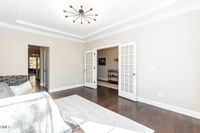 a kitchen with a dining table chairs refrigerator and cabinets