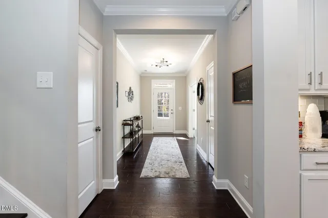 a kitchen with stainless steel appliances granite countertop a table chairs sink refrigerator and cabinets