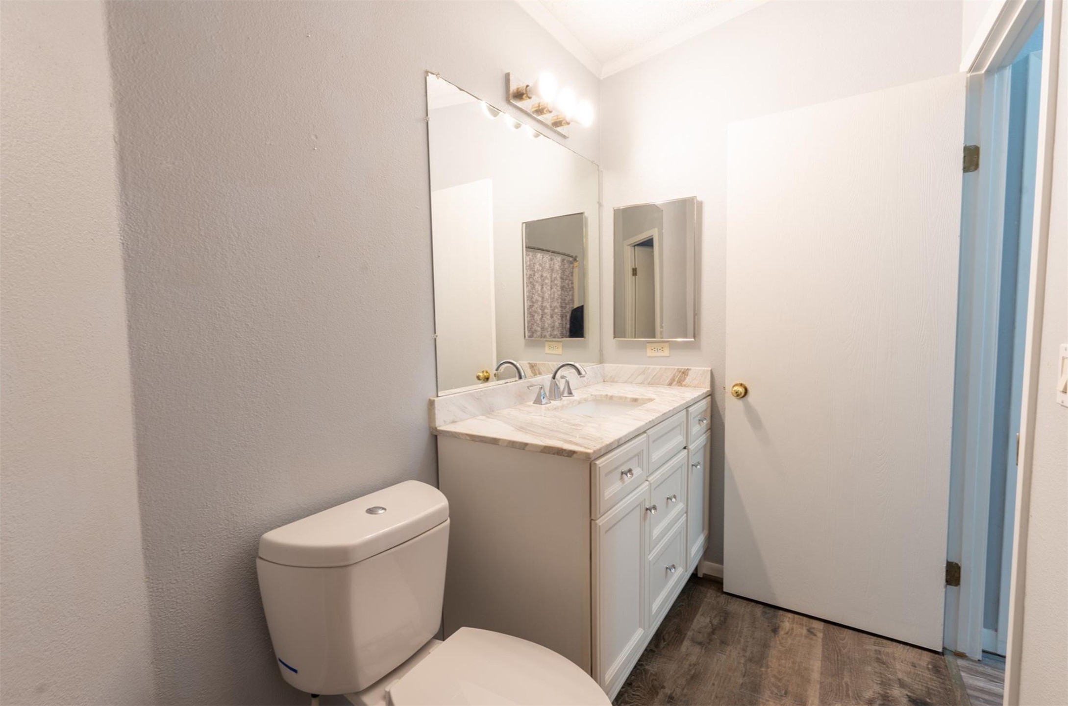 314 County Road 3577 Cleveland, TX 77327 - Photo 19 of 23 a spacious bathroom with a toilet sink and mirror