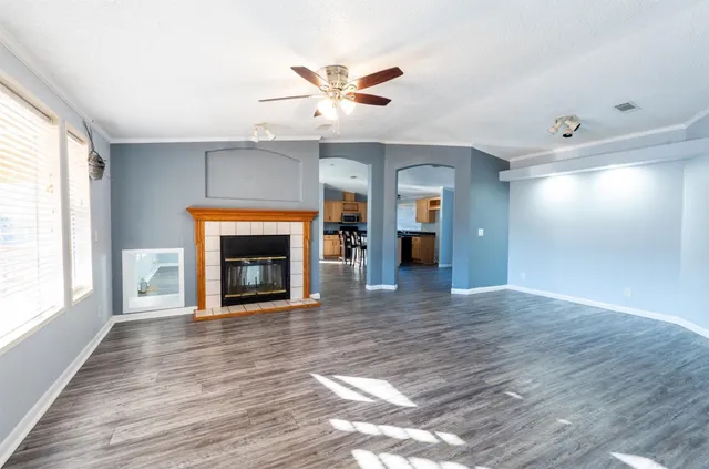 a view of an empty room with a fireplace and a window