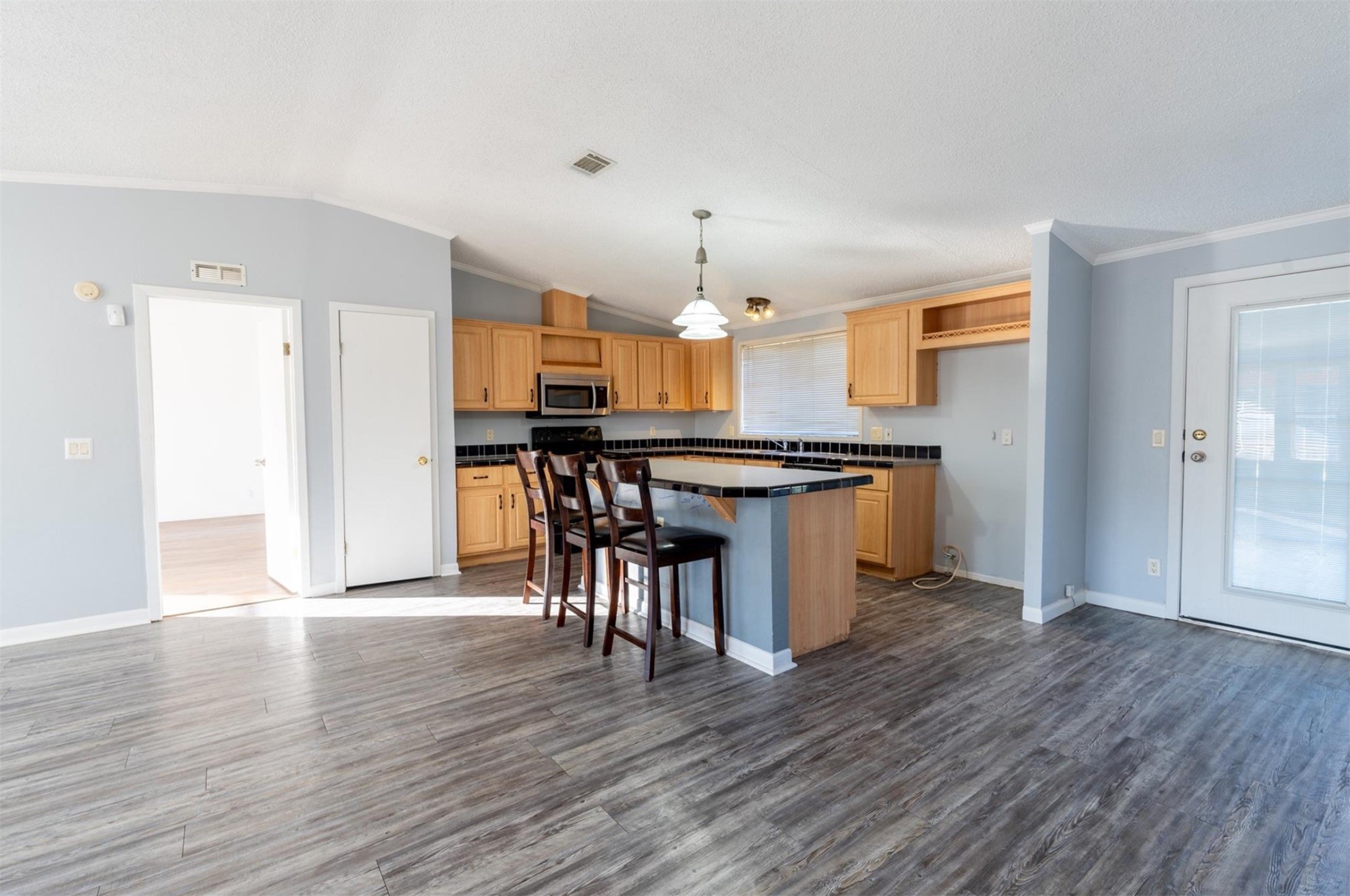 314 County Road 3577 Cleveland, TX 77327 - Photo 5 of 23 a kitchen with stainless steel appliances a dining table chairs and wooden floor
