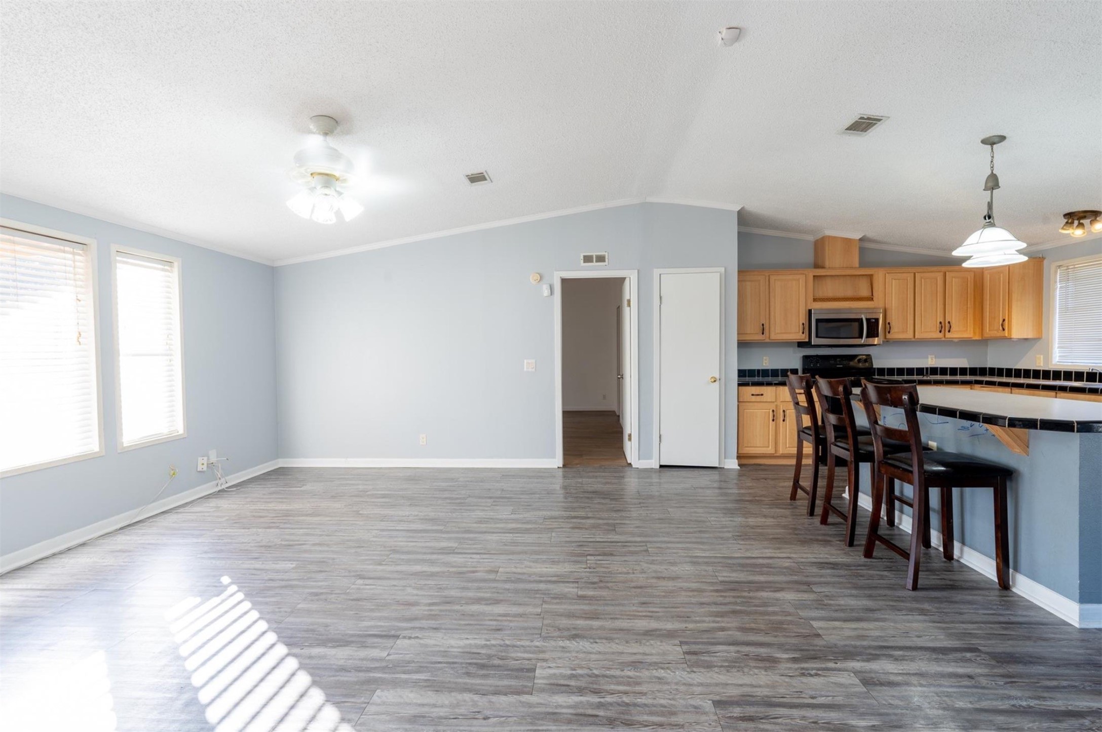 314 County Road 3577 Cleveland, TX 77327 - Photo 6 of 23 a view of kitchen with furniture and wooden floor