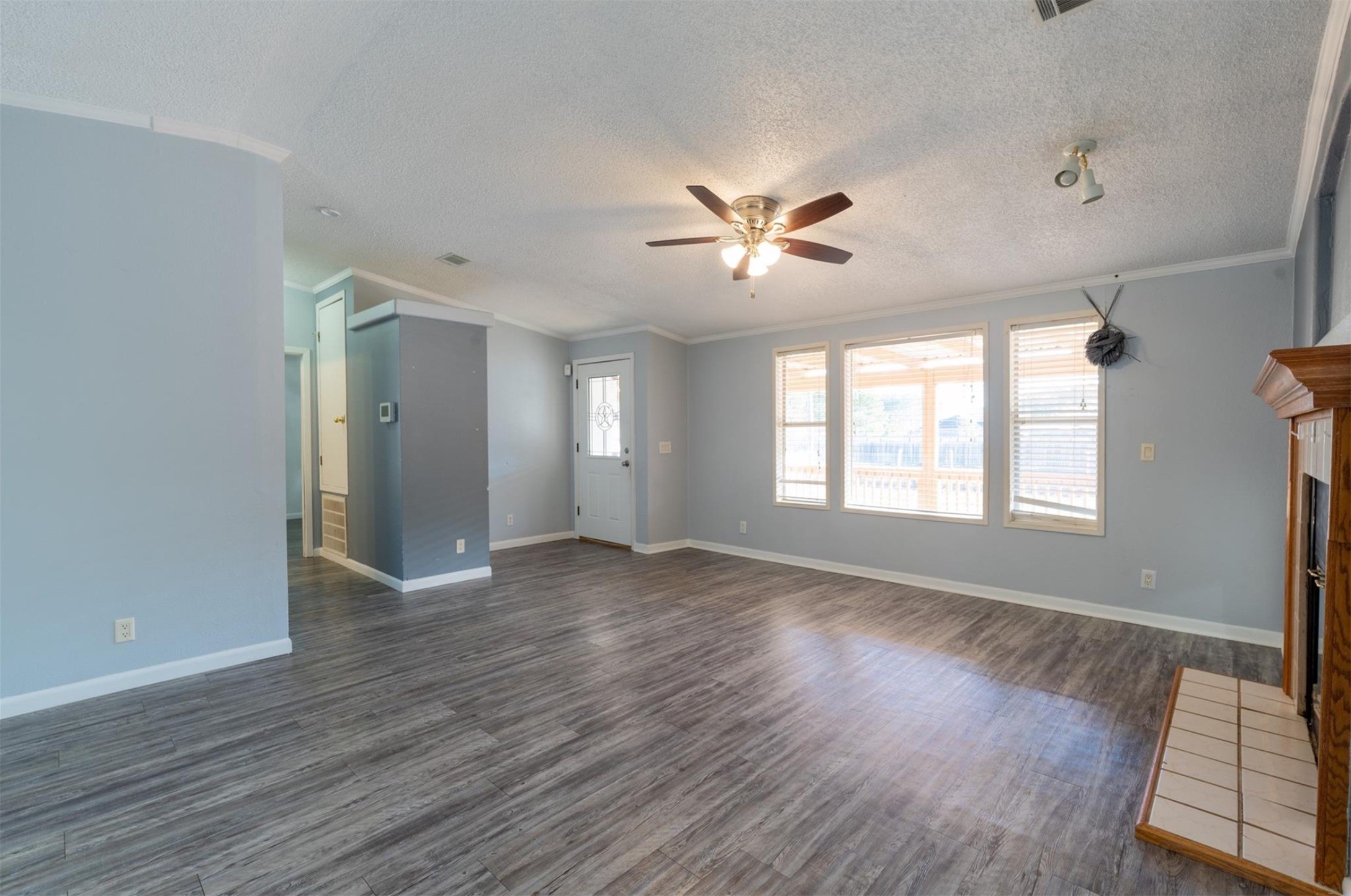 314 County Road 3577 Cleveland, TX 77327 - Photo 8 of 23 a view of an empty room with a window and wooden floor