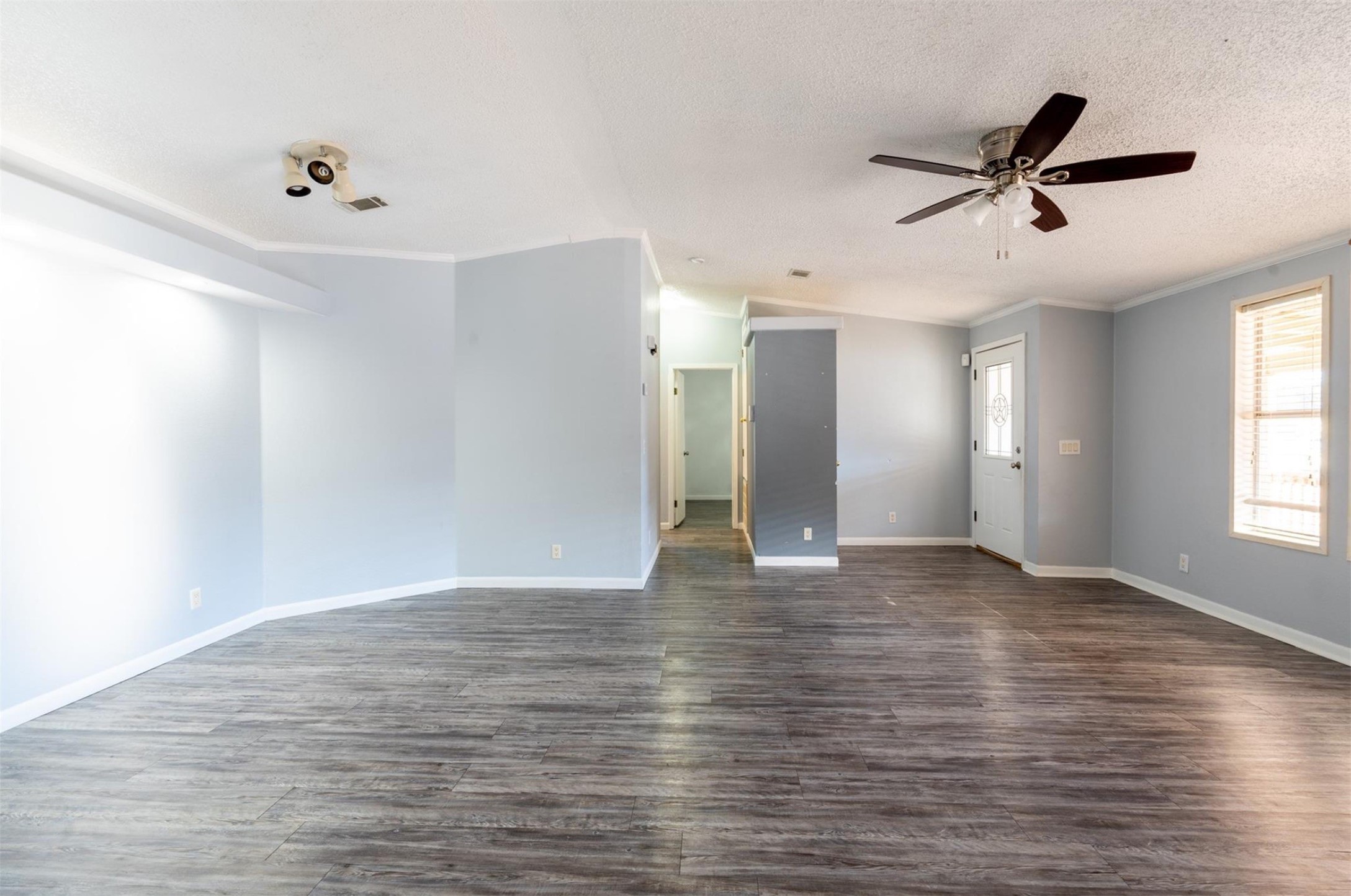 314 County Road 3577 Cleveland, TX 77327 - Photo 9 of 23 a view of an empty room with wooden floor and a window