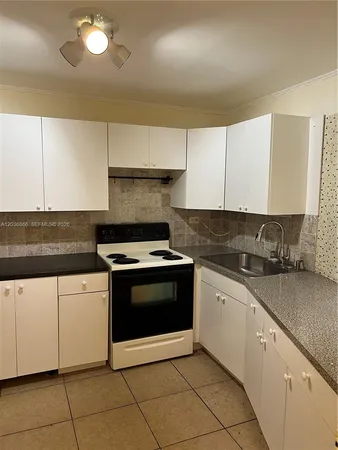 a kitchen with stainless steel appliances granite countertop a sink and a stove
