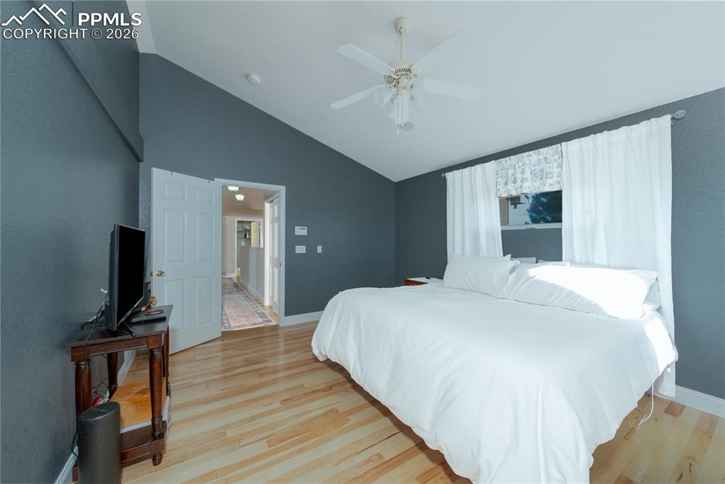 9385 Winged Foot Road Peyton, CO 80831 - Photo 11 of 50 a bedroom with a bed and a flat screen tv