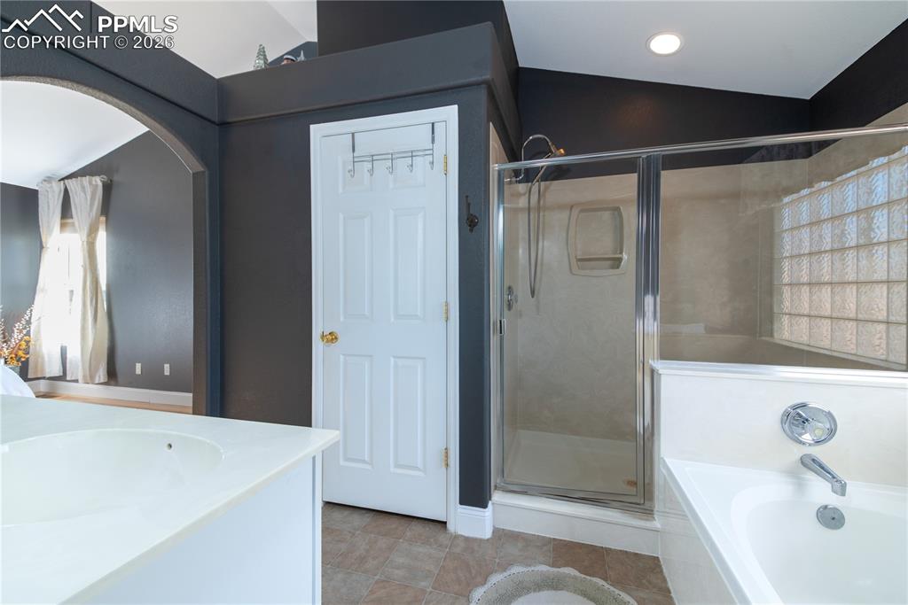 9385 Winged Foot Road Peyton, CO 80831 - Photo 13 of 50 a bathroom with a tub a sink and a shower