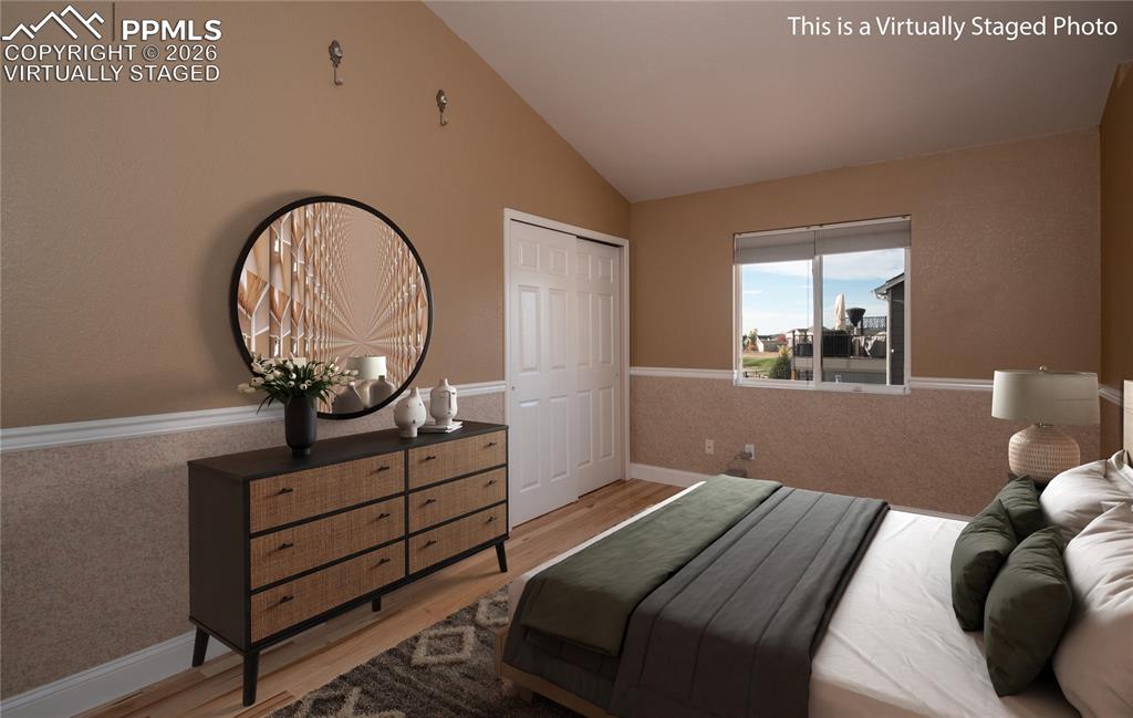 9385 Winged Foot Road Peyton, CO 80831 - Photo 15 of 50 a bed sitting in a bedroom next to a window
