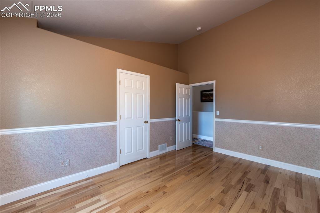 9385 Winged Foot Road Peyton, CO 80831 - Photo 17 of 50 a view of an empty room with wooden floor