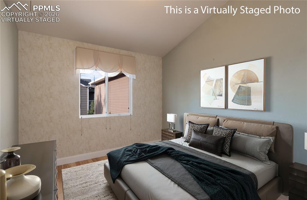9385 Winged Foot Road Peyton, CO 80831 - Photo 18 of 50 a bedroom with a bed and a couch