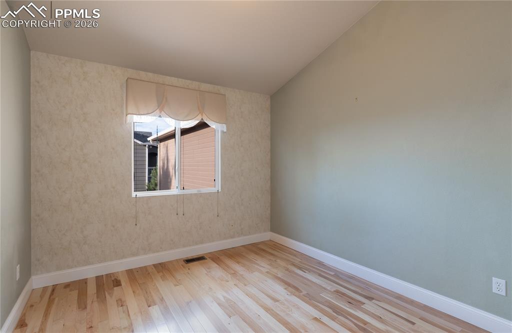 9385 Winged Foot Road Peyton, CO 80831 - Photo 19 of 50 a view of an empty room with wooden floor and a window