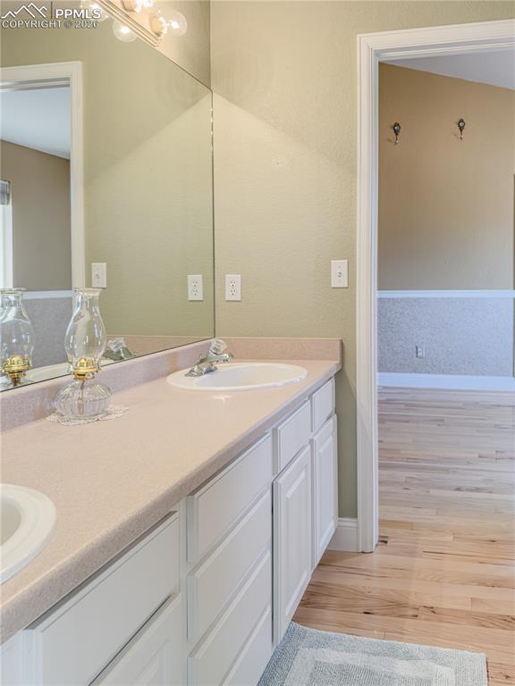 9385 Winged Foot Road Peyton, CO 80831 - Photo 21 of 50 a bathroom with a double vanity sink and a mirror