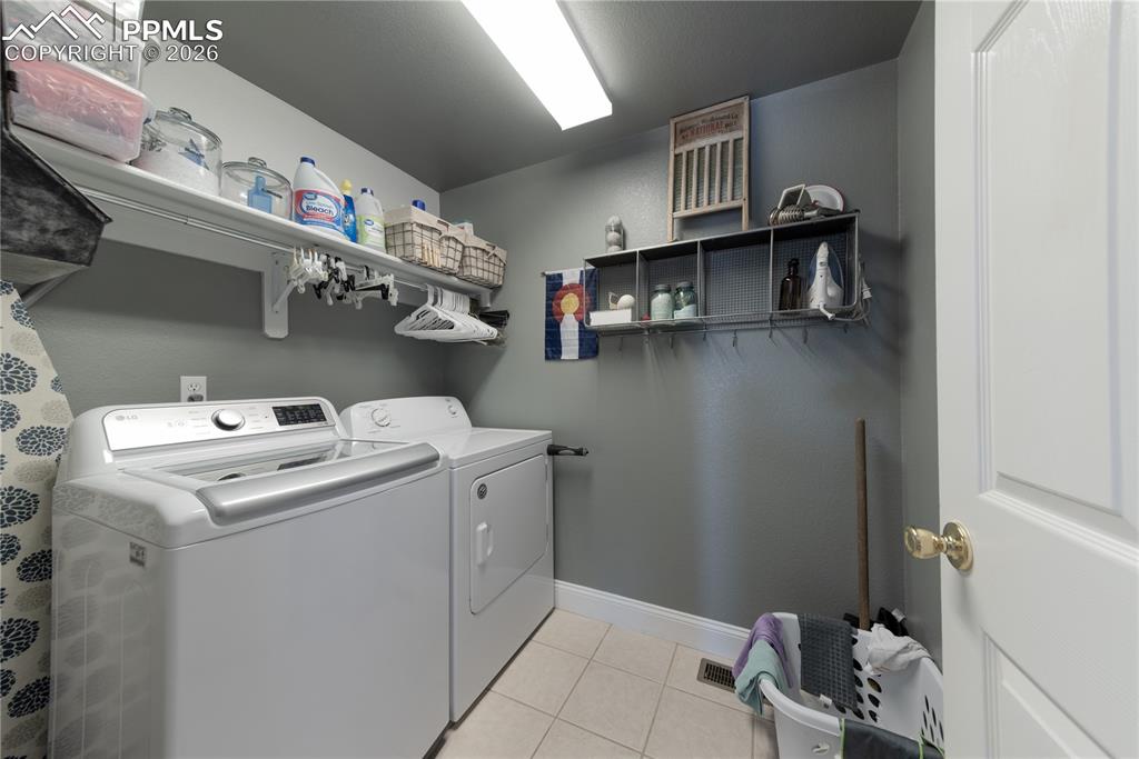 9385 Winged Foot Road Peyton, CO 80831 - Photo 24 of 50 a utility room with dryer and washer