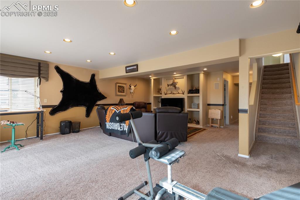 9385 Winged Foot Road Peyton, CO 80831 - Photo 25 of 50 a room with gym equipment and windows