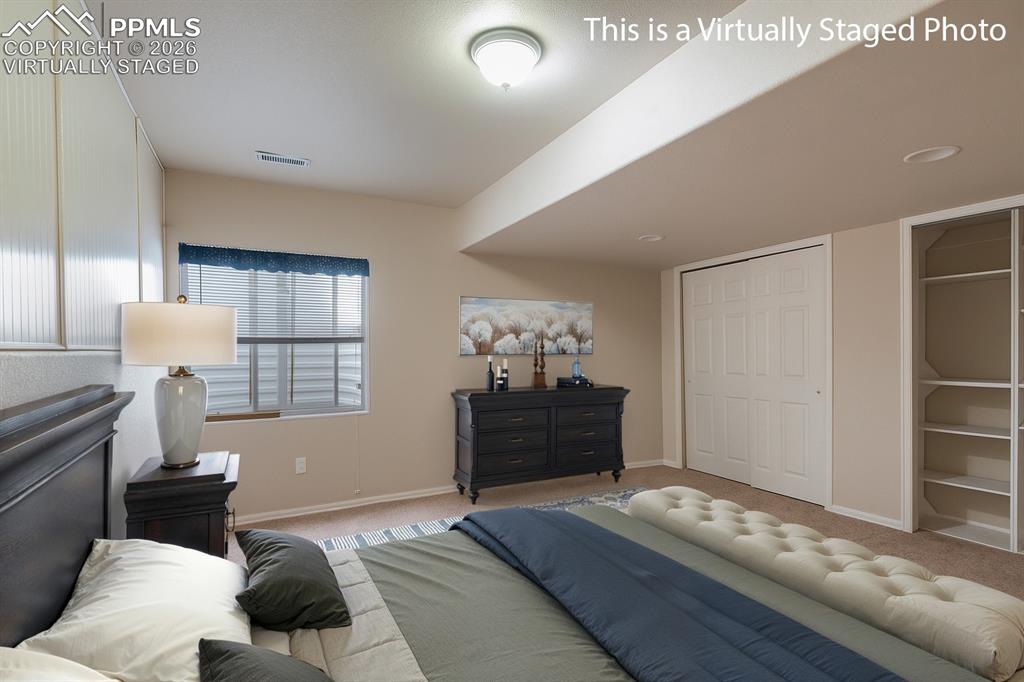 9385 Winged Foot Road Peyton, CO 80831 - Photo 29 of 50 a bedroom with furniture and wooden floor