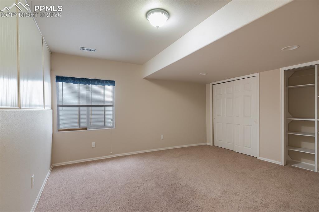 9385 Winged Foot Road Peyton, CO 80831 - Photo 30 of 50 an empty room with windows