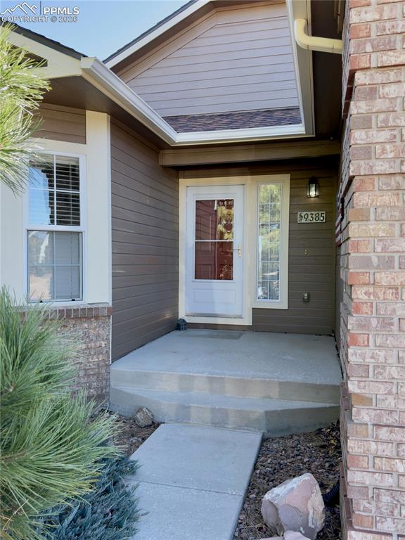 9385 Winged Foot Road Peyton, CO 80831 - Photo 3 of 50 a front view of a house with garden