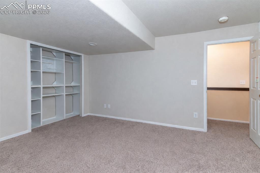 9385 Winged Foot Road Peyton, CO 80831 - Photo 31 of 50 a view of an empty room with a cabinet and a window