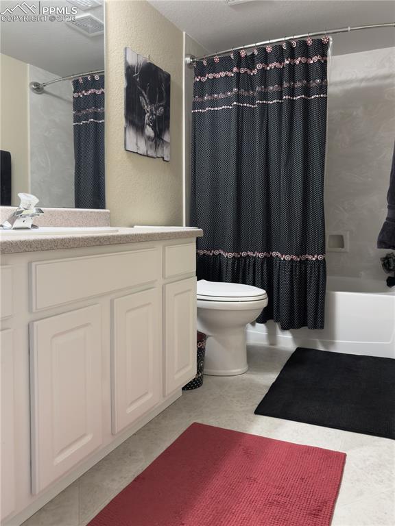 9385 Winged Foot Road Peyton, CO 80831 - Photo 34 of 50 a bathroom with a sink a toilet a mirror and shower