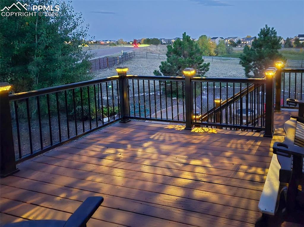 9385 Winged Foot Road Peyton, CO 80831 - Photo 39 of 50 a view of balcony with wooden floor and outdoor seating