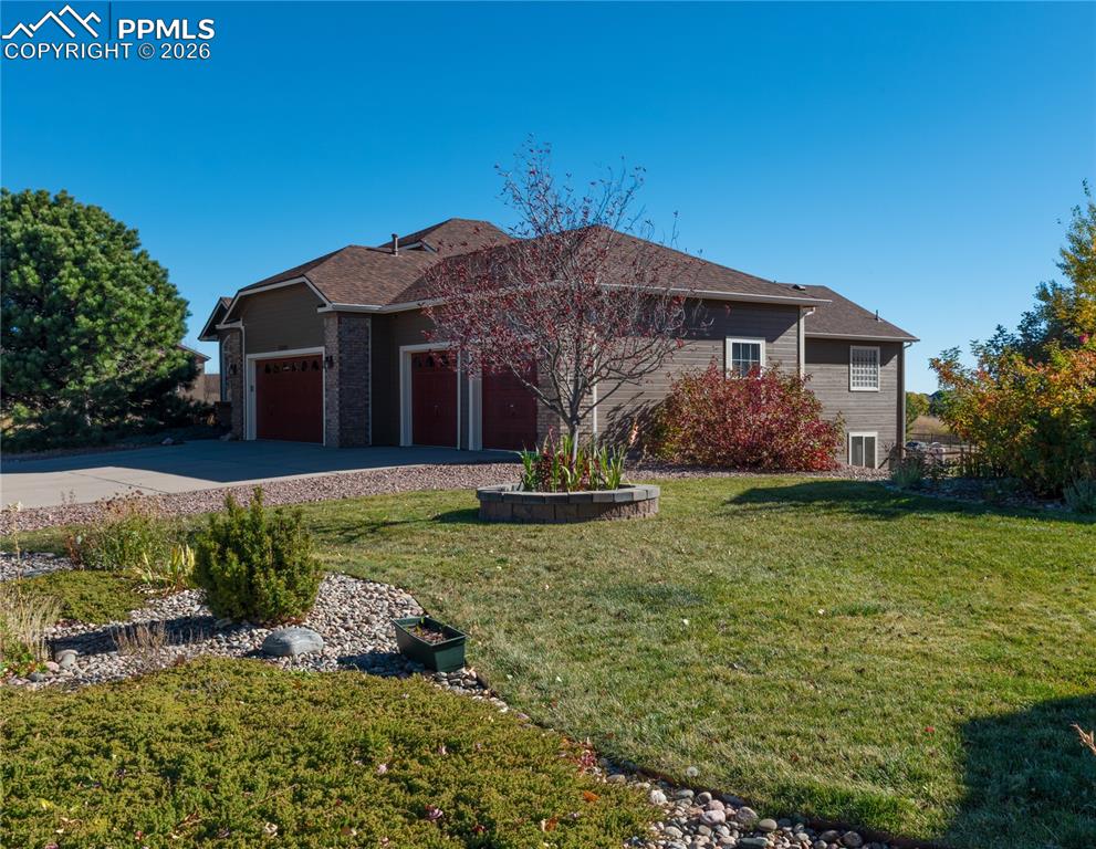 9385 Winged Foot Road Peyton, CO 80831 - Photo 41 of 50 a front view of a house with a yard